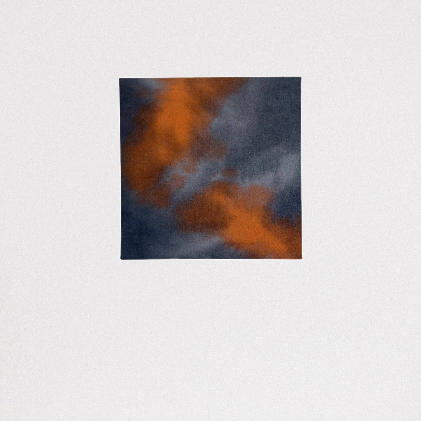 16 x 16 inch canvas painted in a cloud pattern with shades of gray, blue and orange.