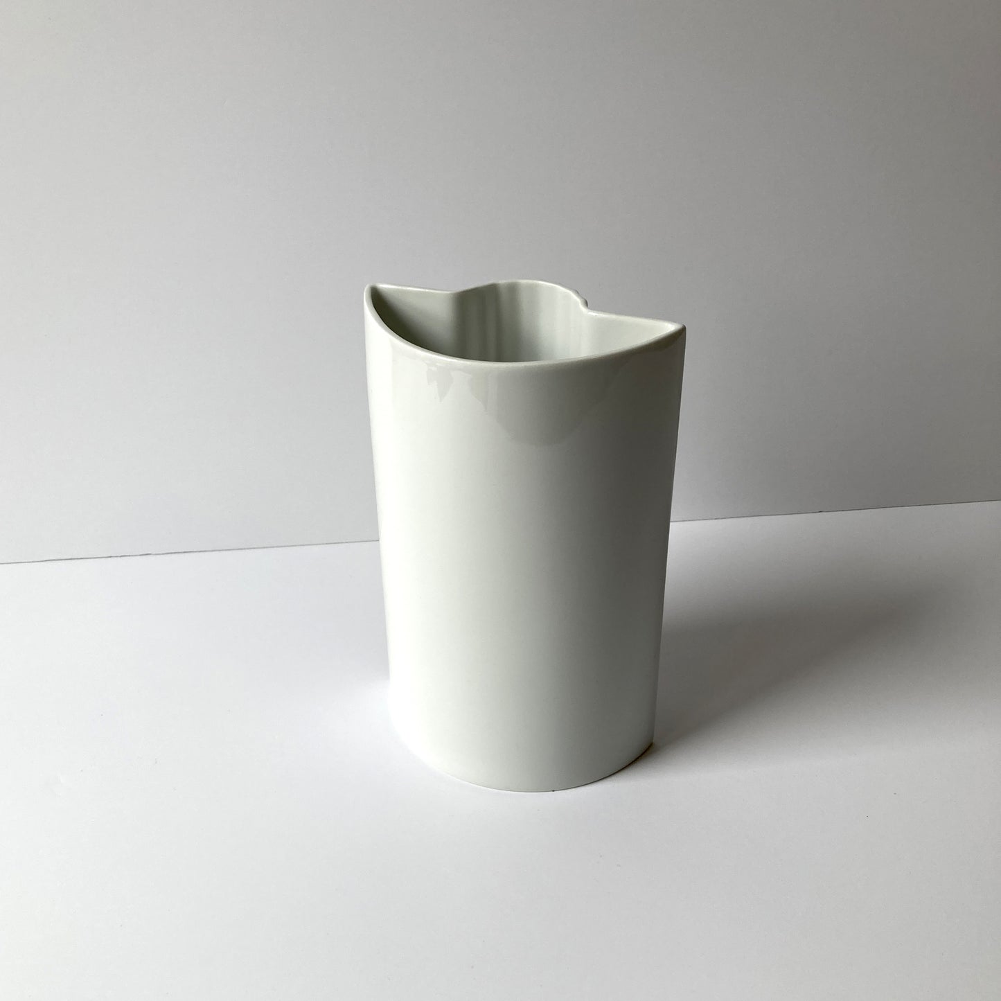 Pair of white vases by Thomas and Rosenthal Plissee vase by Ambrogio Pozzi. The geometric shapes of this pair beautifully complement each other.