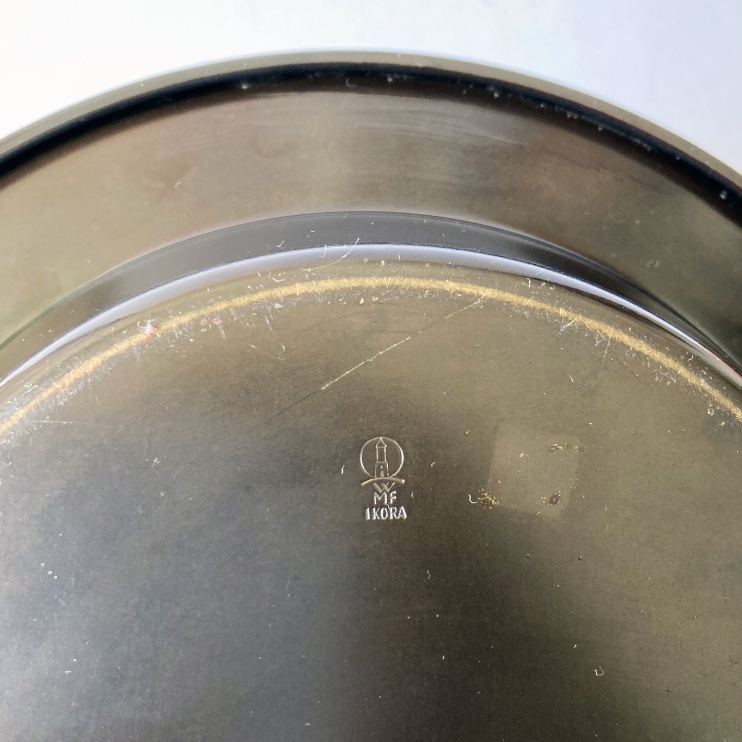 Rare Paul Haustein, WMF Ikora metal catchall/ ashtray with glass insert. The patinated green metal contrasts beautifully with the etched gold and dark brown pattern seen on the dish. The glass insert has beautifully bevelled edges and fits the metal dish perfectly, it has protected the face of the metal dish.