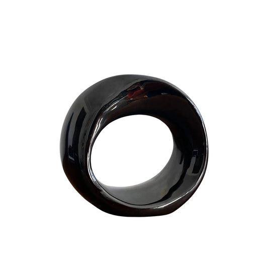 A glossy black ceramic twisted orb sculpture with a smooth finish.