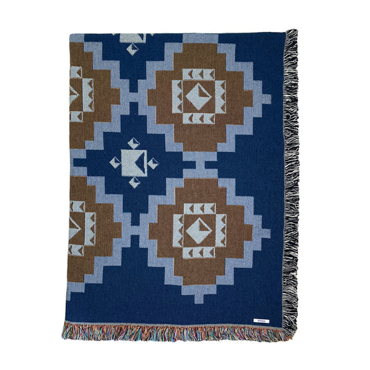 A navy and ochre geometric patterned woven cotton throw with fringe edge, displayed on a white background.