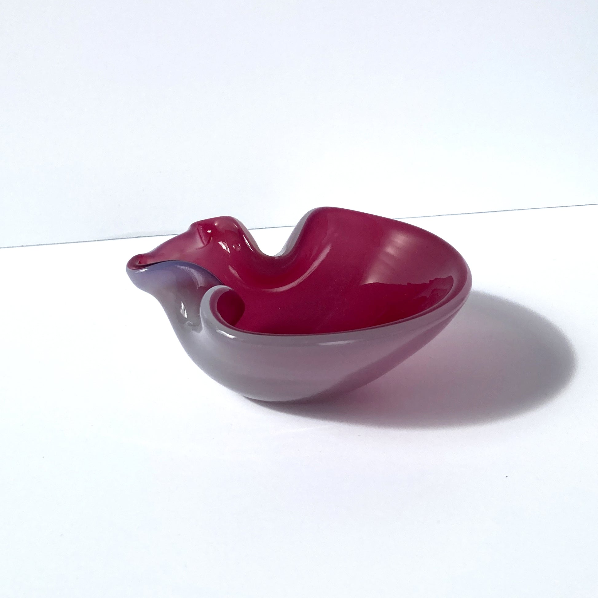 Stunning, unique Venetian hand blown bowl/ catchall. Beautiful cranberry pink interior with opal exterior, creating a luminous mauve shade. 