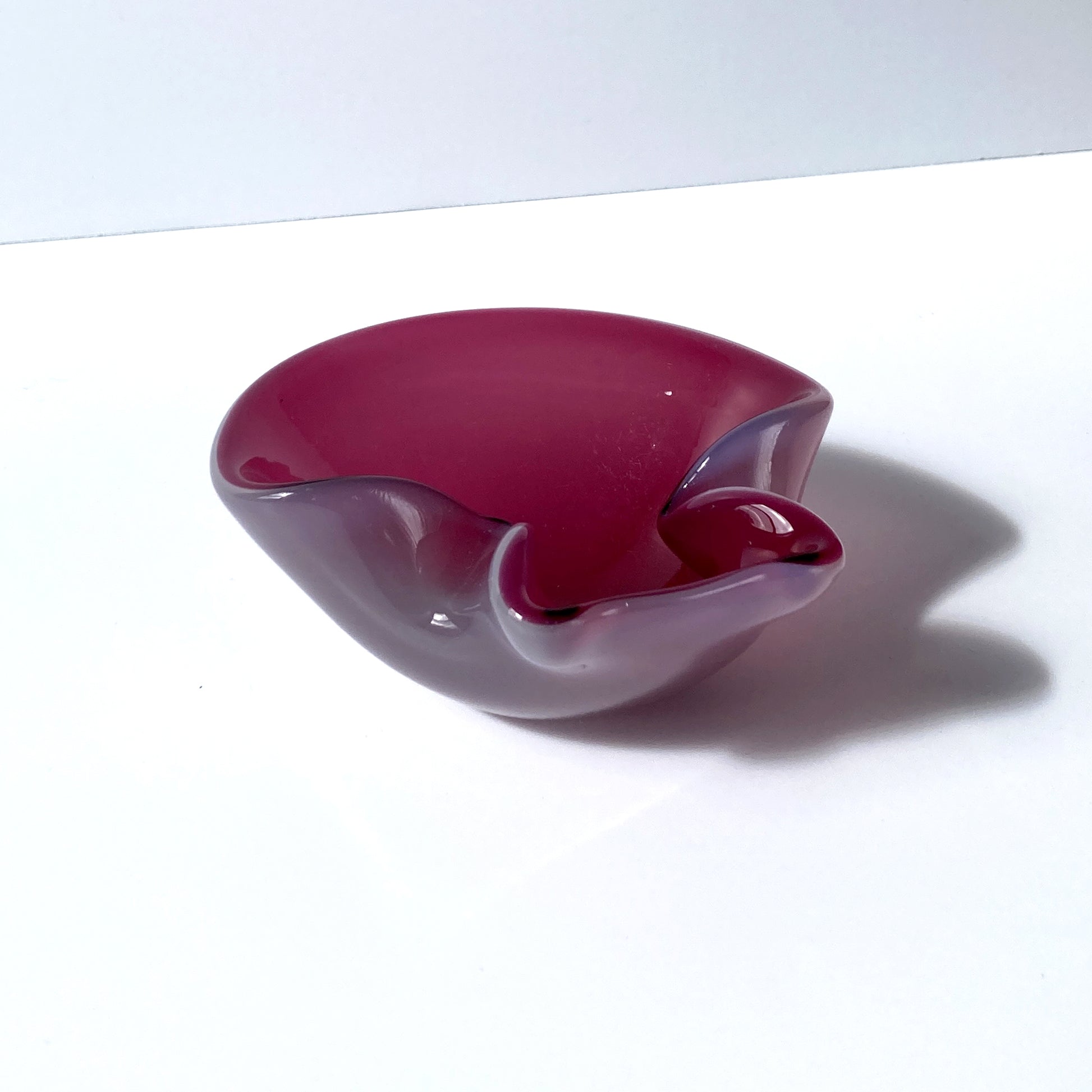 Stunning, unique Venetian hand blown bowl/ catchall. Beautiful cranberry pink interior with opal exterior, creating a luminous mauve shade. 