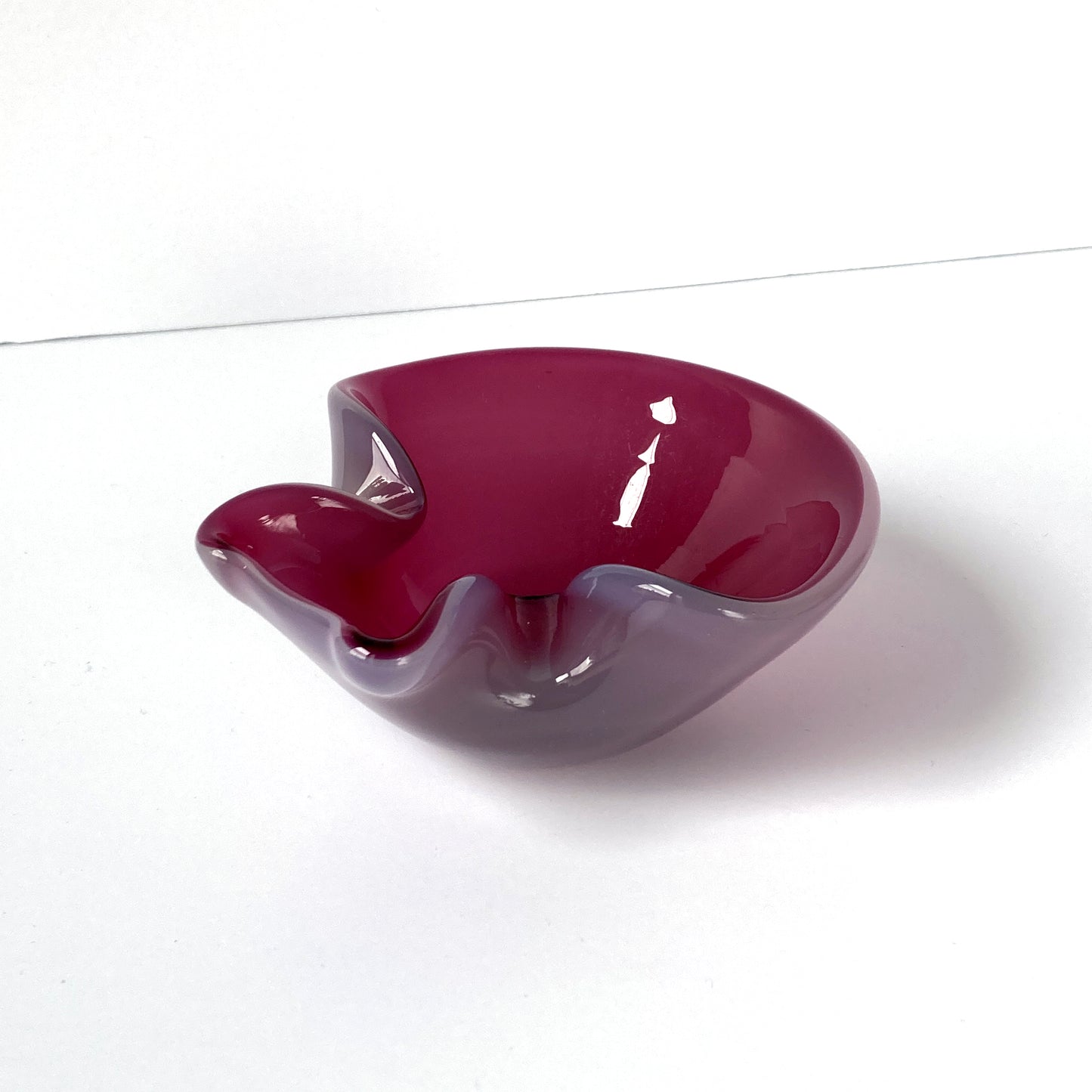 Stunning, unique Venetian hand blown bowl/ catchall. Beautiful cranberry pink interior with opal exterior, creating a luminous mauve shade. 