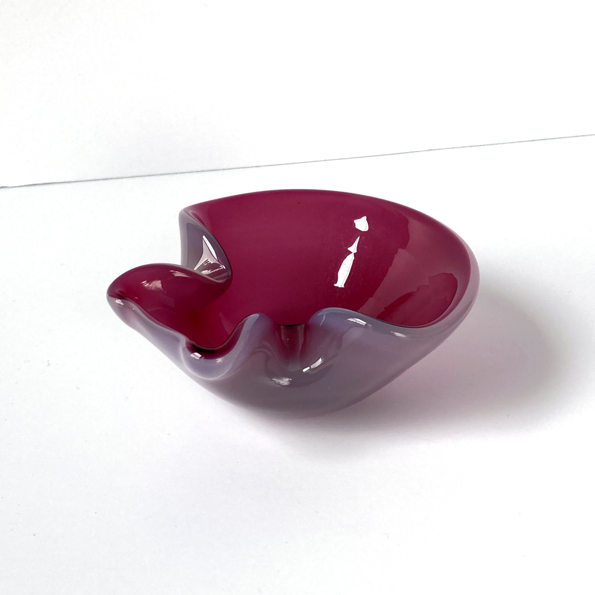 Stunning, unique Venetian hand blown bowl/ catchall. Beautiful cranberry pink interior with opal exterior, creating a luminous mauve shade. 