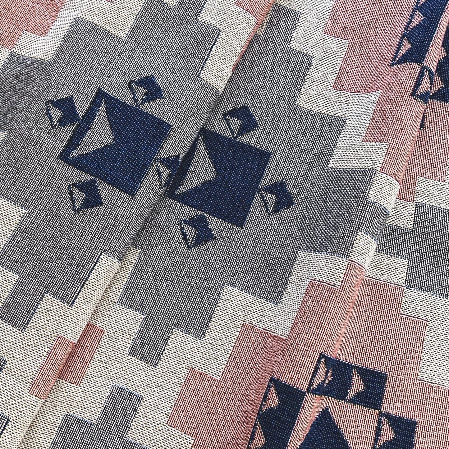 Detail of gray and pink geometric throw blanket, cotton