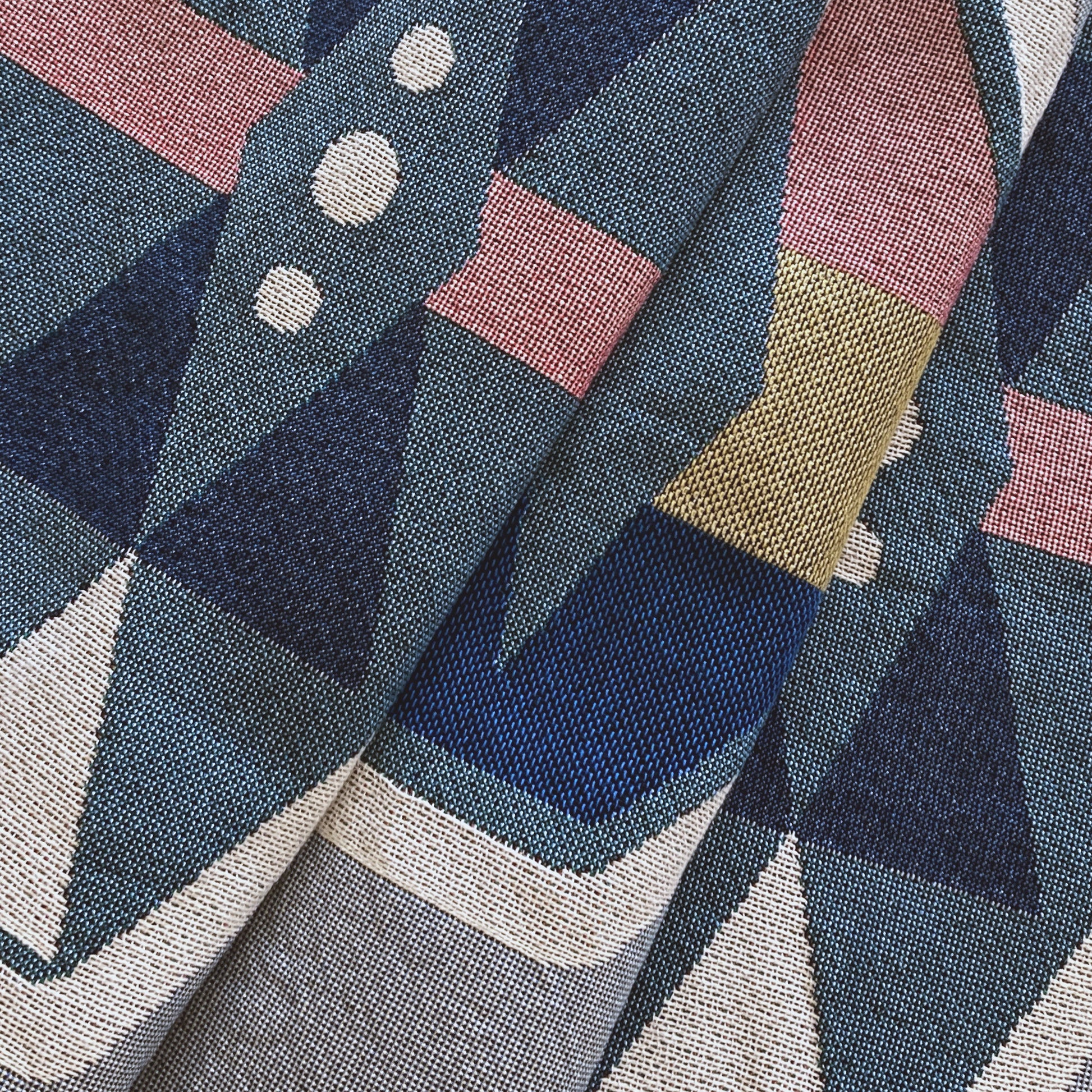 Fog gray geo woven throw with fringe edge. Woven with recycled cotton on a jacquard loom, made in the US. Each throw measures 54 x 72 inches.
