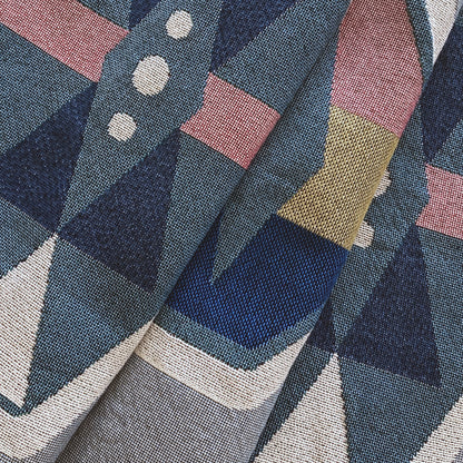 Fog gray geo woven throw with fringe edge. Woven with recycled cotton on a jacquard loom, made in the US. Each throw measures 54 x 72 inches.
