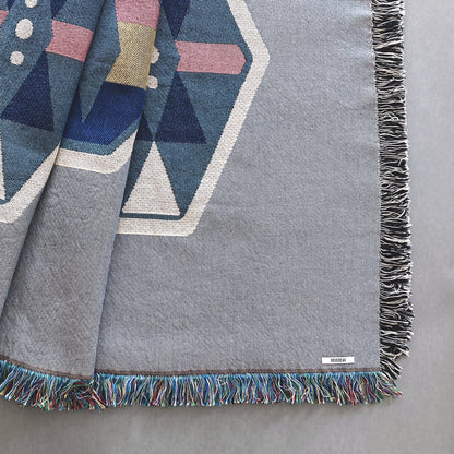 Fog gray geo woven throw with fringe edge. Woven with recycled cotton on a jacquard loom, made in the US. Each throw measures 54 x 72 inches.
