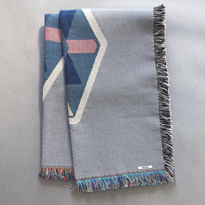 Fog gray geo woven throw with fringe edge. Woven with recycled cotton on a jacquard loom, made in the US. Each throw measures 54 x 72 inches.