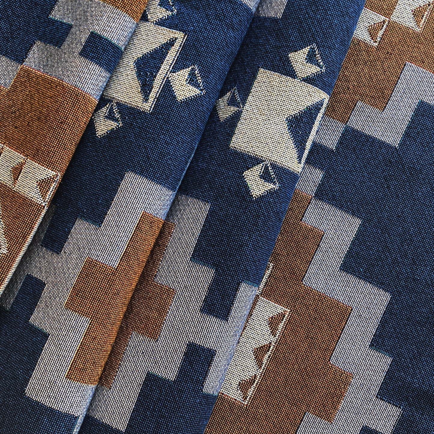 Navy and ochre geometric print woven throw with fringe edge. Woven with recycled cotton on a jacquard loom, made in the US. Each throw measures 54 x 72 inches.

This geometric patterned throw is inspired by early 20th century woven coverlets. The updated, bold geometric pattern offers a fresh perspective on a long-forgotten craft.
