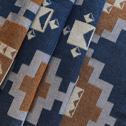 Navy and ochre geometric print woven throw with fringe edge. Woven with recycled cotton on a jacquard loom, made in the US. Each throw measures 54 x 72 inches.

This geometric patterned throw is inspired by early 20th century woven coverlets. The updated, bold geometric pattern offers a fresh perspective on a long-forgotten craft.
