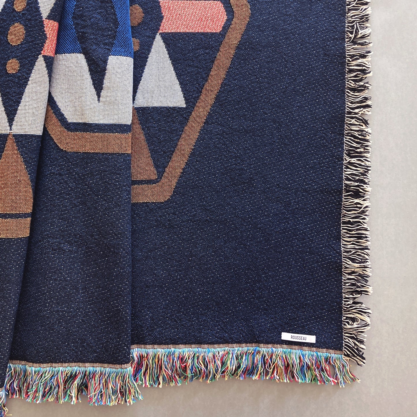 Twilight navy geo woven throw with fringe edge. Woven with recycled cotton on a jacquard loom, made in the US. Each throw measures 54 x 72 inches.