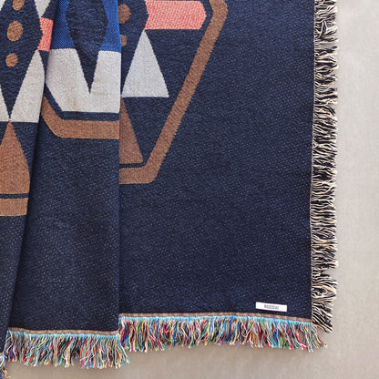 Twilight navy geo woven throw with fringe edge. Woven with recycled cotton on a jacquard loom, made in the US. Each throw measures 54 x 72 inches.
