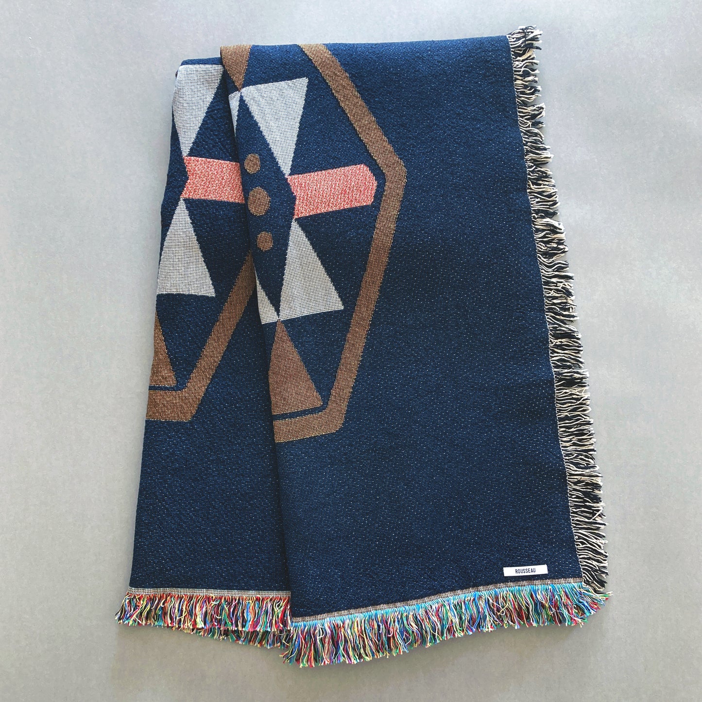 Twilight navy geo woven throw with fringe edge. Woven with recycled cotton on a jacquard loom, made in the US. Each throw measures 54 x 72 inches.