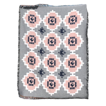 Gray geometric print woven throw with fringe edge, with accents of pink, white and navy. Woven with recycled cotton on a jacquard loom, made in the US. Each throw measures 54 x 72 inches.

This geometric patterned throw is inspired by early 20th century woven coverlets. The updated, bold geometric pattern offers a fresh perspective on a long-forgotten craft.