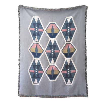 Fog gray geo woven throw with fringe edge. Woven with recycled cotton on a jacquard loom, made in the US. Each throw measures 54 x 72 inches.