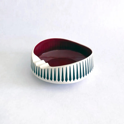 A vintage Hornsea Pottery ashtray with a bold red interior and white and black exterior designed by John Clappison.