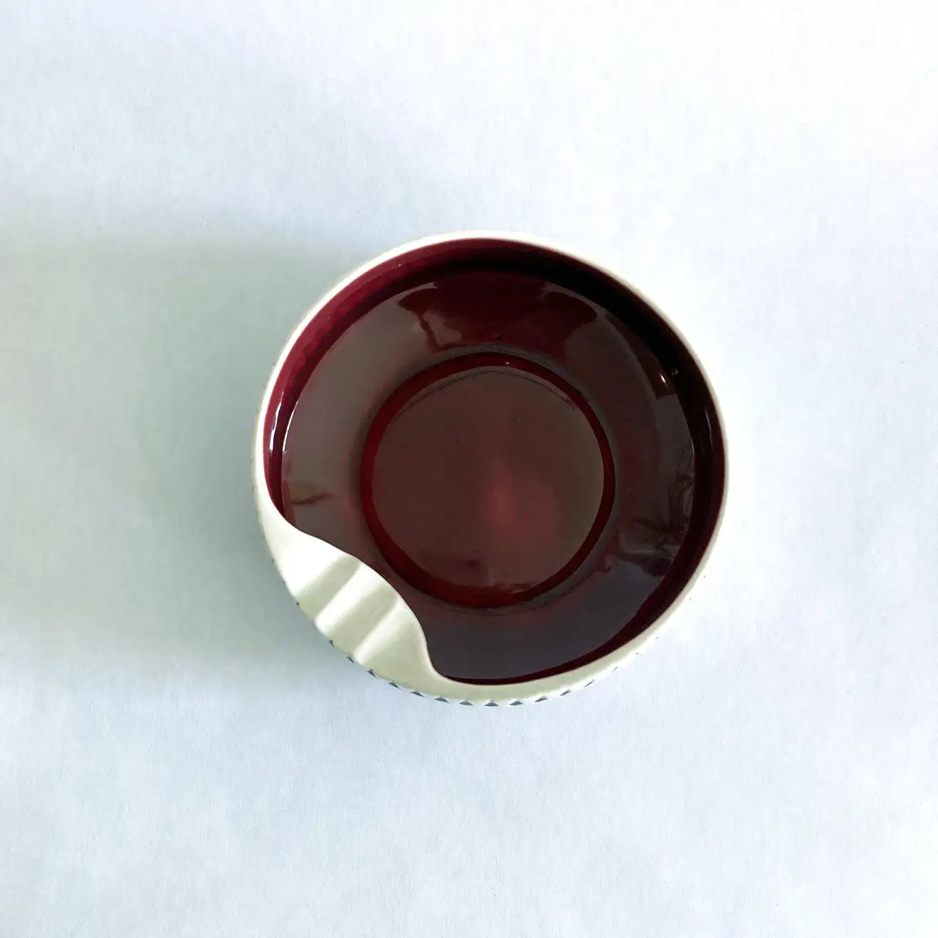 A vintage Hornsea Pottery ashtray with a bold red interior and white and black exterior designed by John Clappison.