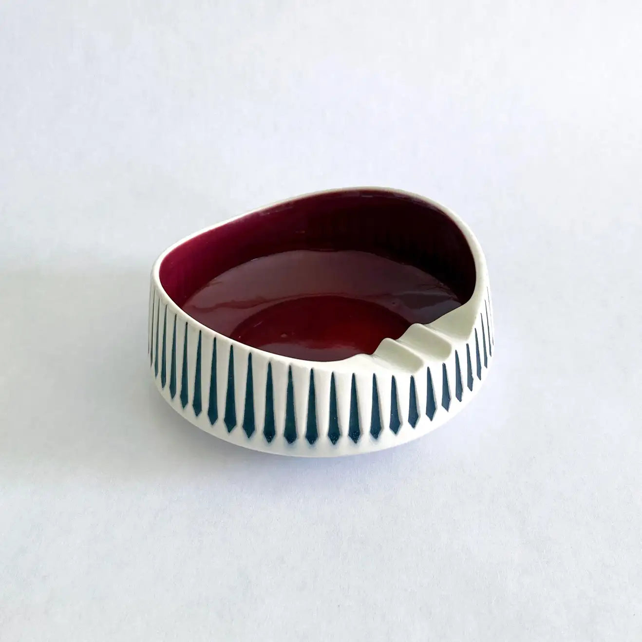 A vintage Hornsea Pottery ashtray with a bold red interior and white and black exterior designed by John Clappison.